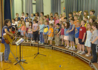Four elementary school classes perform the songs they wrote with Ruth Pelham for an end-of-residency assembly
